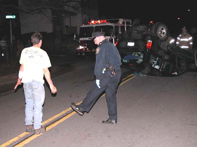 Police officer trying to get a driver who had just been in a serious accident to perform field sobriety tests.